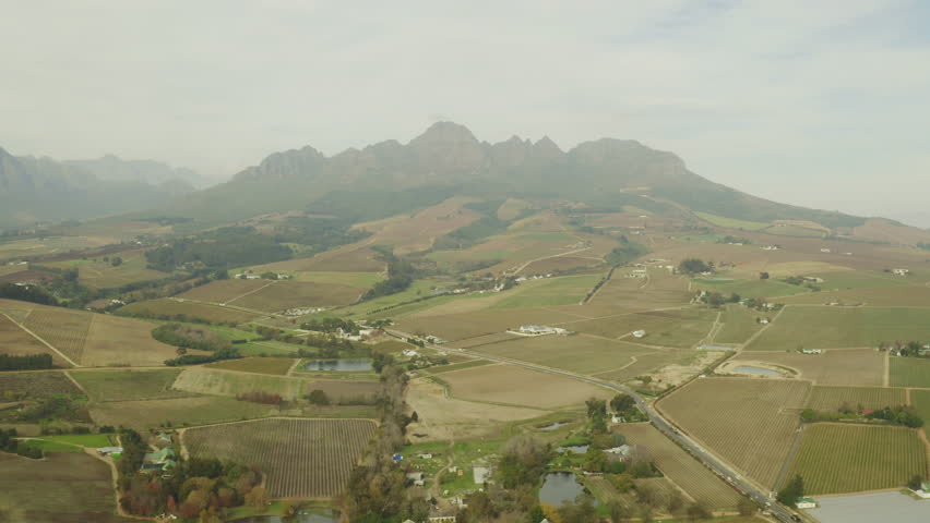 Aerial drone, mountain and farmland in countryside with misty sky above nature of mysterious environment. Top view of calm serene or peaceful cloudy mist of green grass or fields in natural growth | Shutterstock HD Video #1111766965