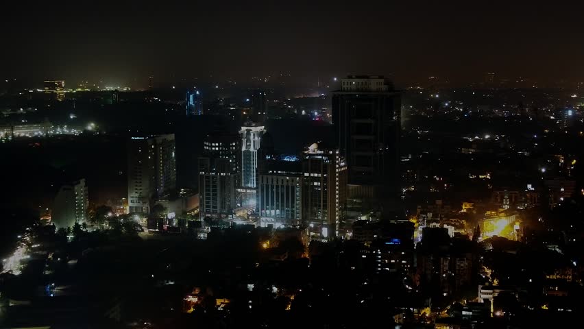 Aerial shot of high-rise skyscrapers at night with illuminated lights flashing in Bangalore during the summer Royalty-Free Stock Footage #1111768017