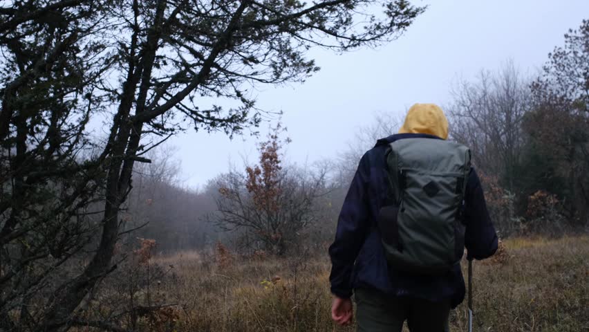 idea and concept of travel and discovery, active lifestyle, hiking. silhouette of man hiker in mountains in sunny autumn day. Self-made person concept