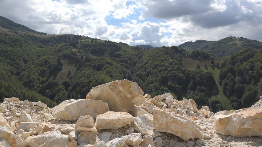 Limestone deposit in quarry near green mountain woods