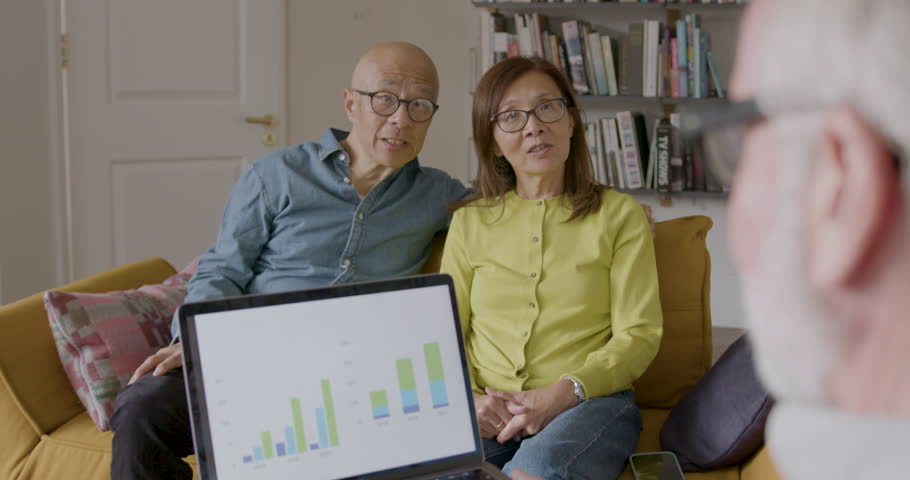 Financial Advisor at Home with Senior Couple on Sofa using Laptop | Shutterstock HD Video #1111773937