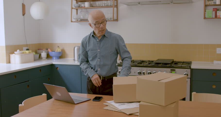 Senior Adult Male Entrepreneur at Home in Kitchen using Smart phone | Shutterstock HD Video #1111773985