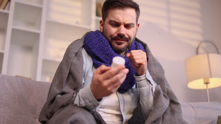 Confused mature man reading medical instructions or composition and refuses to take the drug at home Nervous sick male checking pills for ingredients and information and dissatisfied indoors | Shutterstock HD Video #1111778959