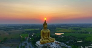 
aerial view The sun was above the head of the biggest golden Buddha at sunset.
landmark of Buddhism in Thailand.
video 4K Nature video High quality footage for worship and travel concep