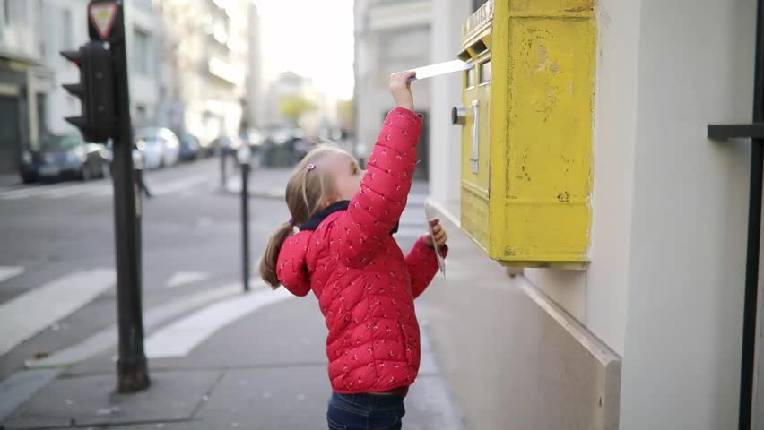 Adorable preschooler girl putting letter in yellow post box on a street of Paris Royalty-Free Stock Footage #1111782889