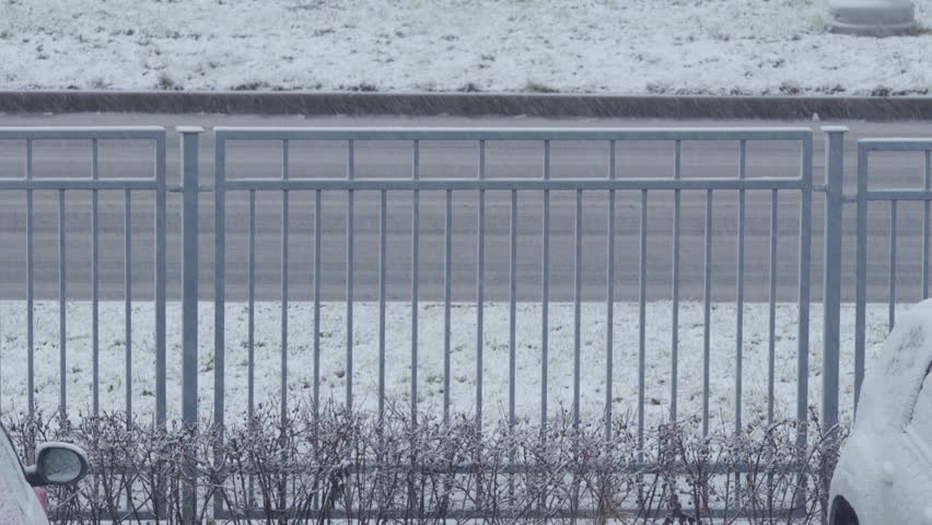 First snow falling on the road and fence in winter | Shutterstock HD Video #1111783473