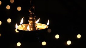 Onam Diwali Vishu Karthika Thrikarthika celebration Indian Festival of Lights, Lighted Oil lamp Nilavilakku or Diya, Deepavali Kerala Traditional Hanging oil lampwith text space, slow motion video