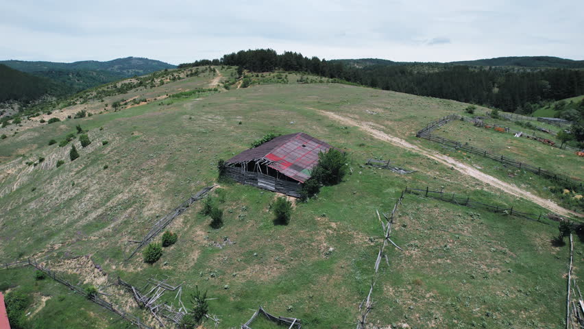 Old mormon barn farm house on mountain hill, aerial shot