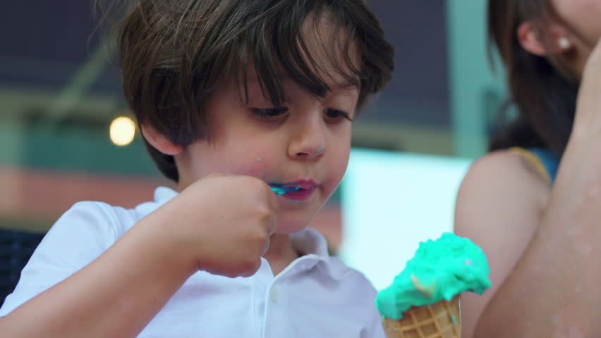Summer Delight of Young Boy with Mom Enjoys Multicolored Ice Cream Outside | Shutterstock HD Video #1111789717