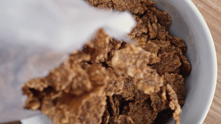 Breakfast Time Captured - Slow-Motion Cereal Pour into Bowl | Shutterstock HD Video #1111789731