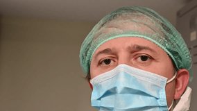 Asian male surgeon in a stressed basque and hair cap in the dressing room after surgery - Powered by Shutterstock - Get 15% off with code: PIKWIZARD15