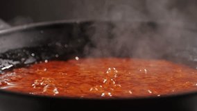 Cooking tomato sauce close-up. Classic homemade Italian tomato sauce for pasta and pizza in the pan. Chef cooking traditional Italian food. - Powered by Shutterstock - Get 15% off with code: PIKWIZARD15