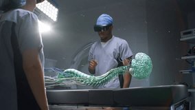 African American surgeon and nurse in VR headsets work in surgery room using futuristic holographic display. 3D graphics of human skeleton and organs. AI technology in medicine. Healthcare innovation. - Powered by Shutterstock - Get 15% off with code: PIKWIZARD15
