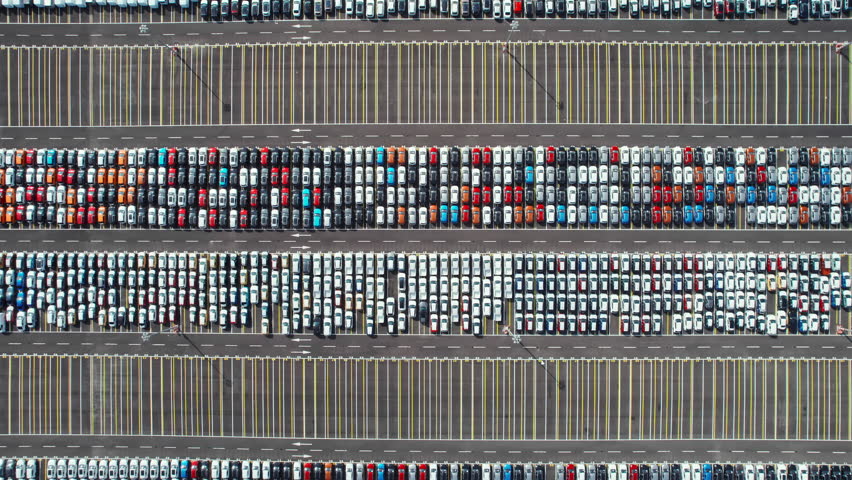 Aerial top down view of new cars parked for sale in a stock lot row. Dealers inventory for import and export in the global automotive business. Distribution and logistics in the automobile industry | Shutterstock HD Video #1111796333