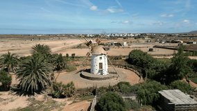 Aerial orbit clip of a historic traditional Canarian windmill near El Cotillo in Fuerteventura Spain	