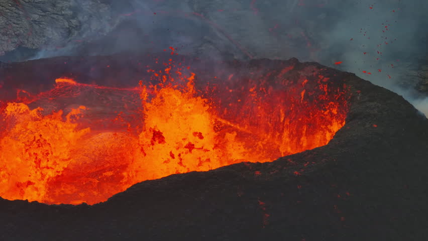 Close up view of active volcanic crater eruption. Hot lava and magma splashing out of crater. Tourist attraction in Iceland Litli-Hrútur eruption 2023. Beautiful and dangerous disaster.