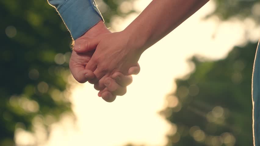 Pair of man, woman separate their hands in front of sun. Separation, separation, quarrel. Closeup of guy lets go of girls hand, separation. Separation of hands of man of woman. Family at sunset Royalty-Free Stock Footage #1111798949
