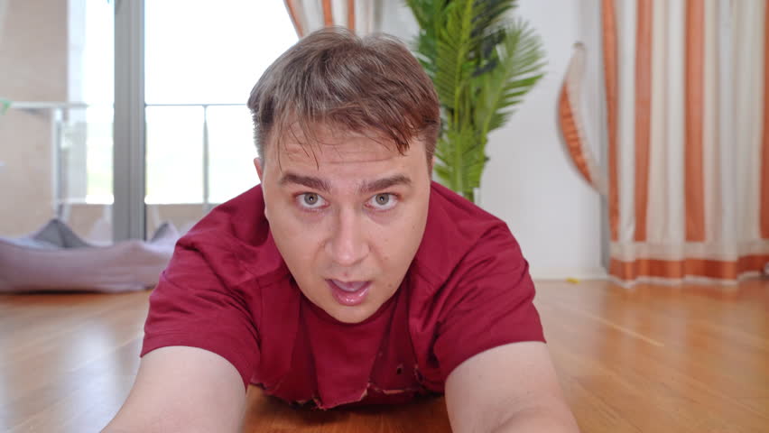 Man dragged across floor released left lying unconscious. Frightened man on floor loses consciousness after being dragged across parquet floor | Shutterstock HD Video #1111801035
