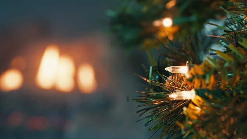 white christmas lights on tree with fireplace in background 