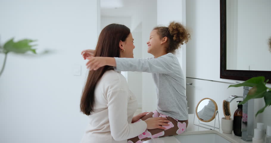 Mother, daughter and hug in bedroom for love, bonding and relationship with happiness, care and peace. Family, woman and girl child with embrace, smile and relax in apartment or house for comfort | Shutterstock HD Video #1111803585