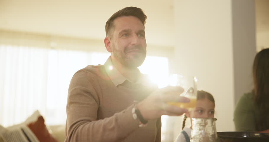 Glass, toast and a man at a family gathering with a drink for celebration at a party or event in a home. Love, smile and cheers in an apartment with a person looking happy in the holiday season | Shutterstock HD Video #1111803591