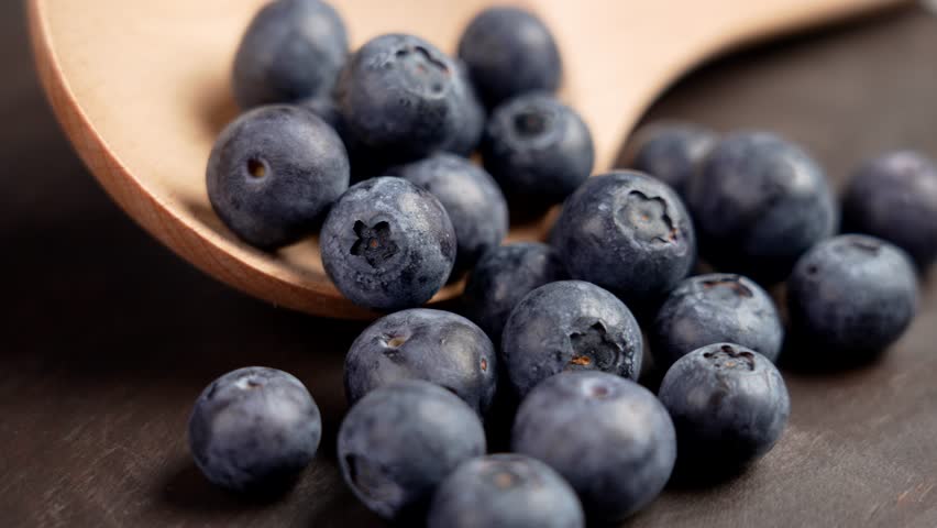 Fresh blueberries and wooden kitchenware close up. Rotation Royalty-Free Stock Footage #1111807473