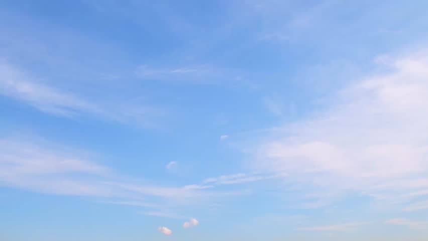 A calm, unobtrusive background with the sky and simple, cirrus clouds. Slowly moving clouds. Royalty-Free Stock Footage #1111808059