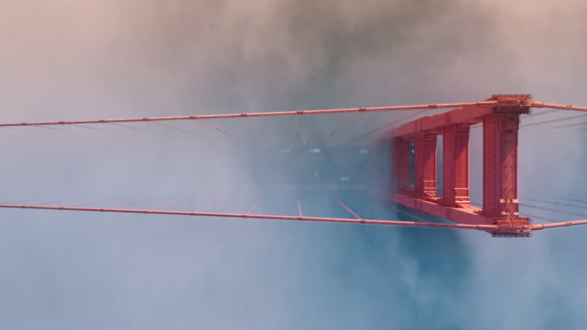 Drone shot of busy traffic on Golden Gate Bridge in the morning mist, San Francisco, California, USA. Top view of cars driving on rout 101 to the city. Tourist landmark, 4k footage in time lapse Royalty-Free Stock Footage #1111809575