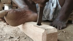 Time lapse video of Carpenter drilling a hole in wood with a tool.