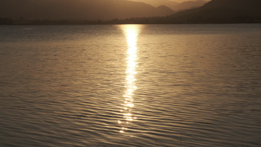 The light reflects on the. water. See the view of the evening sun at the dam | Shutterstock HD Video #1111811661
