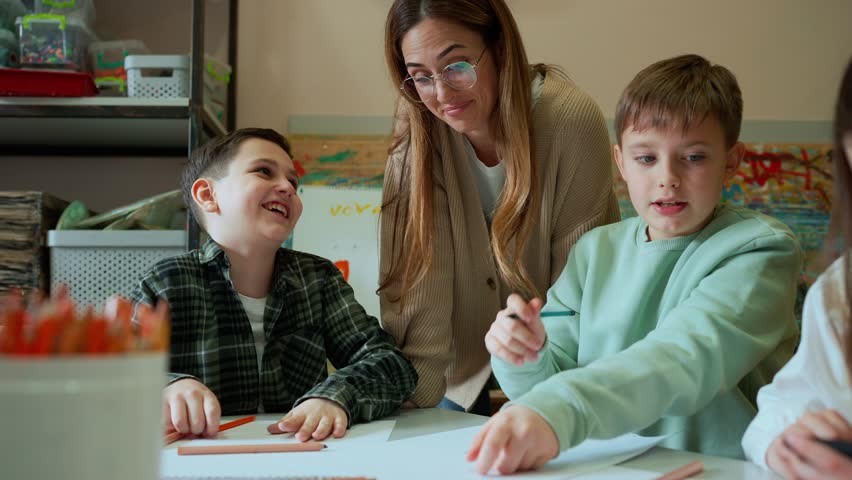 Charming female teacher watches children painting at art school | Shutterstock HD Video #1111816149