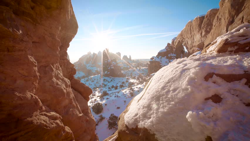 A beautiful view of Window Arch with sunlight and snow in Arches National Park, Utah, USA