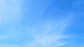 4K : Blue sky timelapse video reveals the ever-changing canvas of the sky. Wispy clouds dance across the brilliant blue expanse, painting a dynamic masterpiece in the heavens. Summer sky background.
