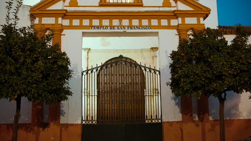 Night view of the Temple of Saint Francis (Templo de San Francisco) in Ayamonte, Huelva, Andalucia, Spain, bathes the historic structure in a serene, ambient glow
