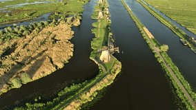 An aerial view of the windmill. Kinderdijk national park. View from a drone. Canals with water for agriculture. Fields and meadows. Landscape from the air.