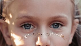 Close-up macro portrait of smiling girl face. Toddler beautiful kid's eyes looking at camera. Positive child opening wide her closed eyes. Blue eyes of blonde female children model. Relax,calm - Powered by Shutterstock - Get 15% off with code: PIKWIZARD15