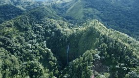 Salto Rodeo waterfall between Bonao lush mountains in Dominican Republic. Aerial drone panoramic view