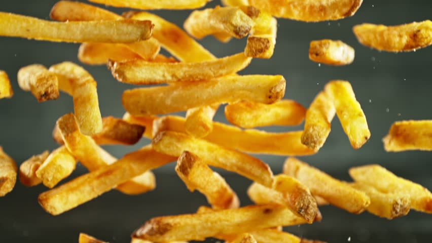Super Slow Motion of Flying French Fries. Filmed on High Speed Cinema Camera, 1000fps, Placed on High Speed Cine Bot. Camera in Motion, Following Objects. Speed Ramp Effect. | Shutterstock HD Video #1111825711