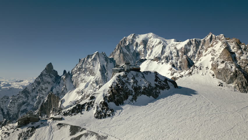Skyway Monte Bianco cableway mountain top with mont blanc and rope team