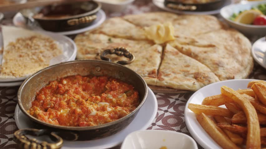 Traditional turkish breakfast, fresh cheese, olive butter and honey, jam, dessert, turkish tea, juice, | Shutterstock HD Video #1111833859
