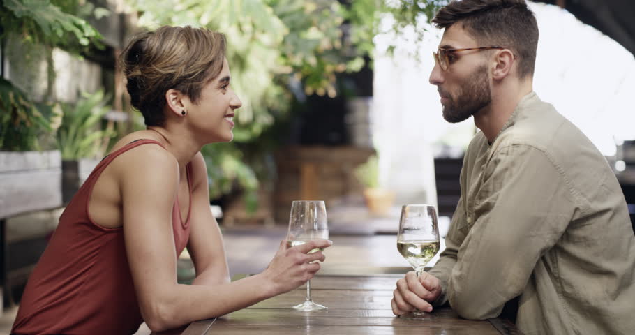 Wine, cheers and a couple on a date at a cafe with love, care and happiness together. Man and woman toast, celebrate and drinking alcohol for anniversary, birthday or bonding at restaurant table | Shutterstock HD Video #1111840137