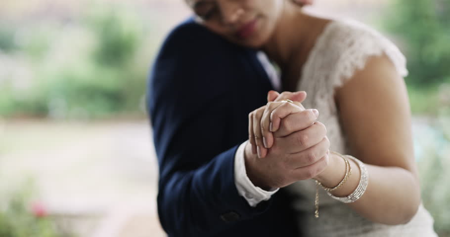 Couple, dancing on wedding day and happy with ceremony, husband and wife for commitment, love and trust. Hand holding, matrimony and slow dance with bride, groom and married in romantic union | Shutterstock HD Video #1111840215