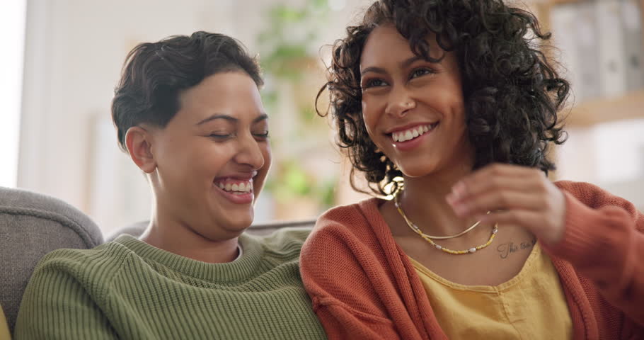 Lgbtq couple, lesbian and women on sofa in home for bonding, connection and relax together. Love, dating and happy people in gay relationship in living room for chatting, discussion and talking | Shutterstock HD Video #1111840401