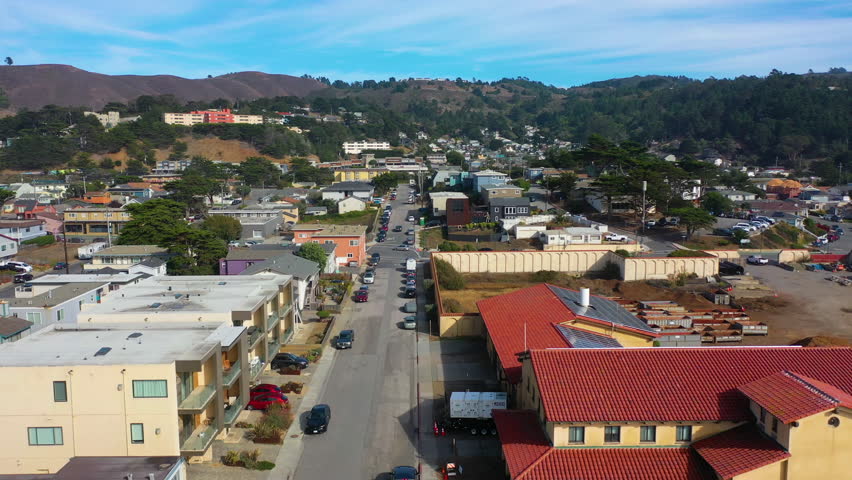 Aerial view low over streets of Pacifica city, sunny day in California, USA Royalty-Free Stock Footage #1111841401