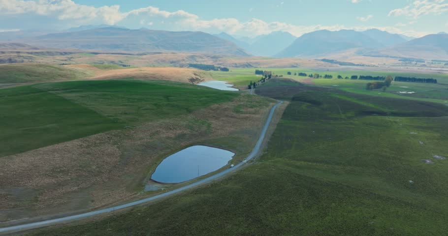 Scenic aerial view of rural Kiwi countryside landscape with green fields at Lake Tekapo in Mackenzie Basin of Canterbury, New Zealand Aotearoa