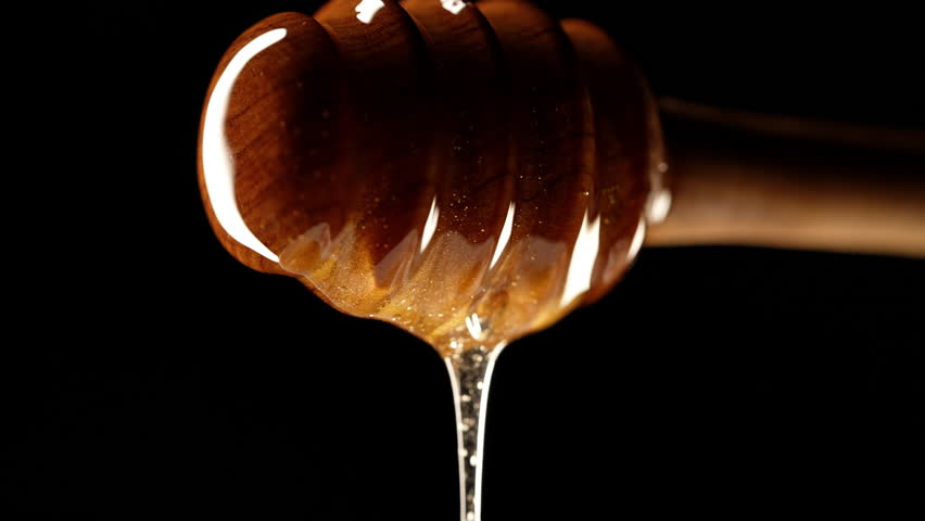 Organic honey flows olive wood dipper stick, tasty process. Apiary, beekeeping | Shutterstock HD Video #1111842253