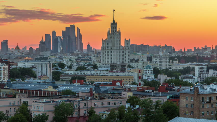 Skyscrapers day to night transition timelapse from rooftop, Kremlin towers and churches, stalin houses at evening aerial panorama in Moscow, Russia. Sunset orange sky