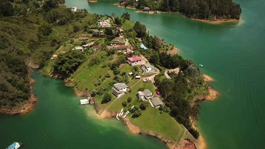 Aerial drone footage of Guatape village near El Penon de Guatape, Medellin in Antioquia, Colombia. Touristic place. Big stone in Colombia. High quality 4k footage.