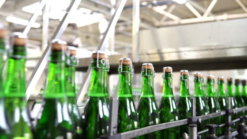 Industrial sparkling wine bottling plant theme. Modern industry production line for champagne alcohol drink bottling and packaging. | Shutterstock HD Video #1111844777