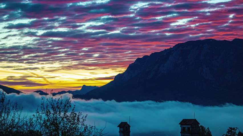 Colorful cloudscape time lapse at sunset over Attersee Lake, Austria